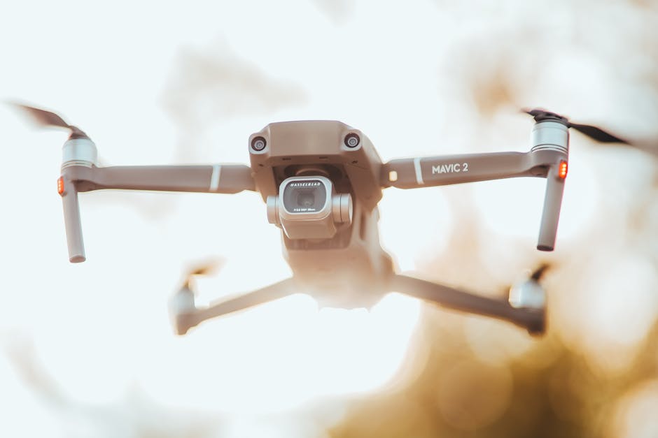 A detailed close-up of the Mavic 2 drone in flight against a blurred outdoor background